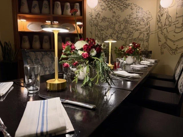 Private events dining room, including floral arrangements and decorative lighting