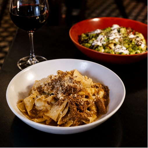 Sunday supper pasta entree with salad and glass of wine